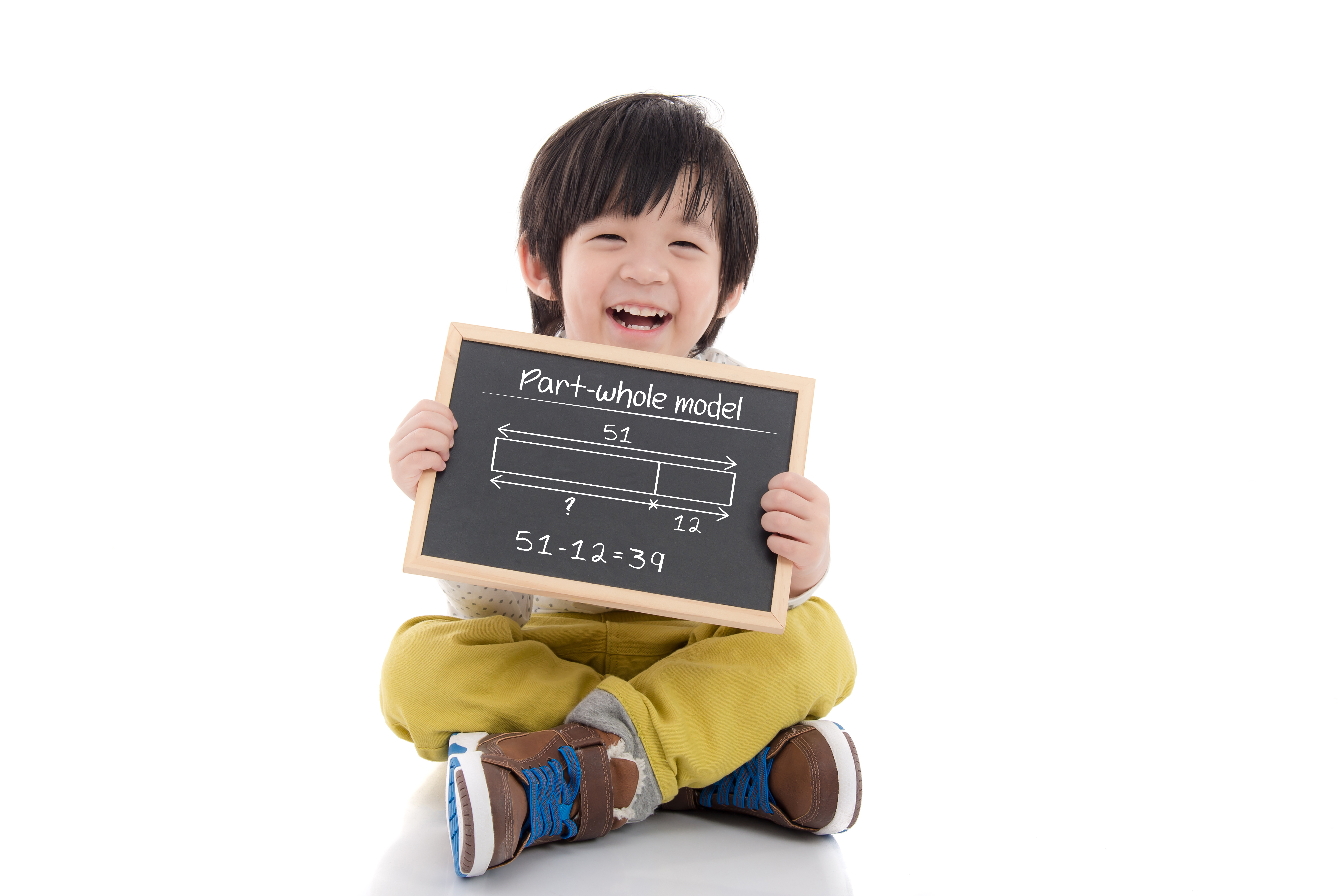 Child holding a writing board with Math on it