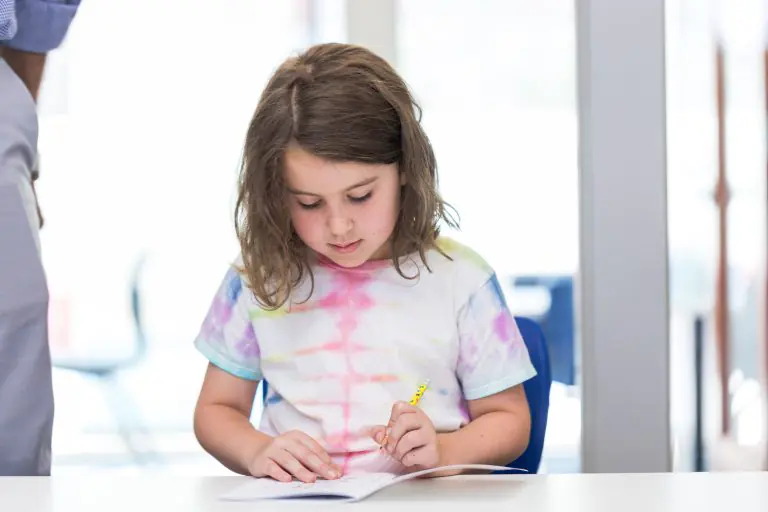 Female student working on Math problem at a desk