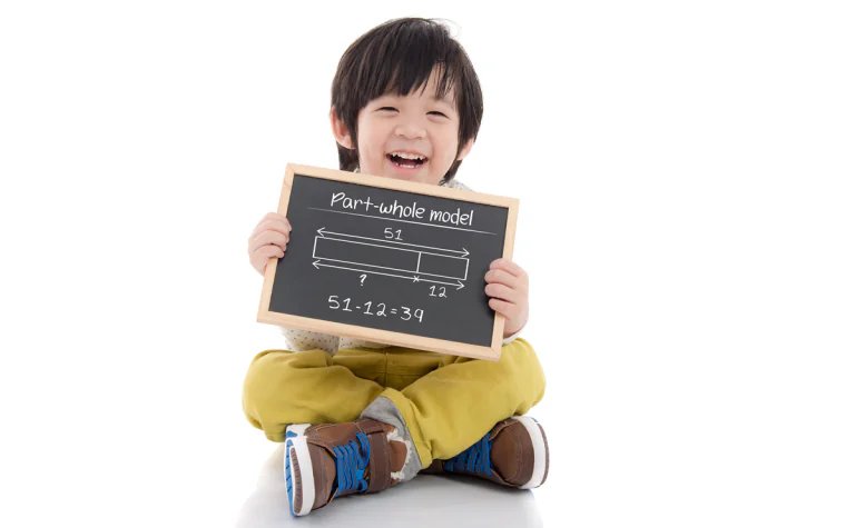 Child holding a writing board with Math on it
